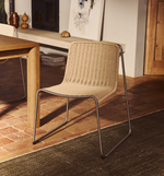 TAVARI Stackable chair in beige synthetic rope cord and brushed-effect stainless steel.