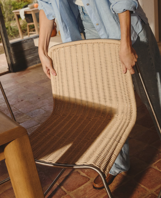 TAVARI Stackable chair in beige synthetic rope cord and brushed-effect stainless steel.
