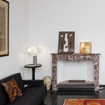 Living room with a fireplace, sofa, and decorative items.